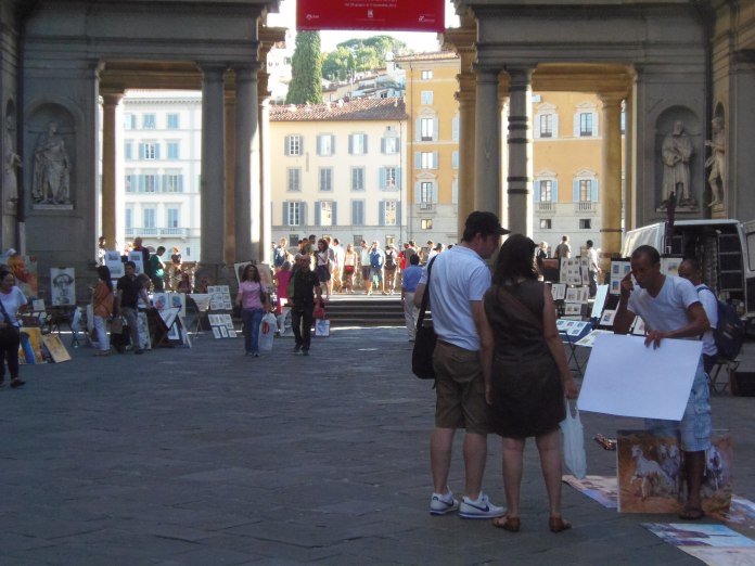 Portraitistes installés entre les deux ailes de la Galeria degli Uffizi.
